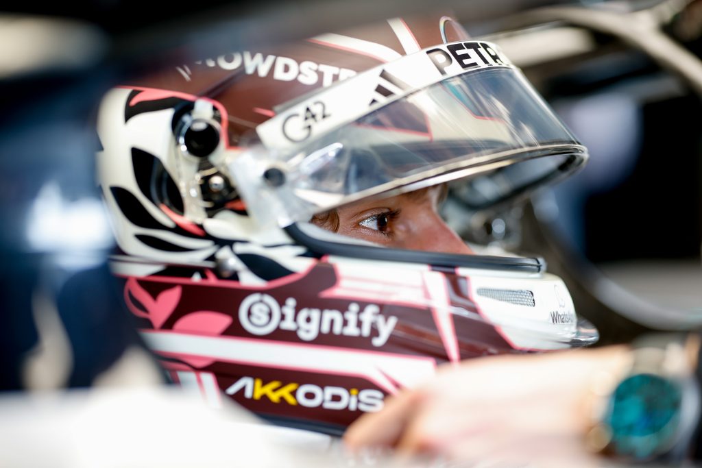 Mercedes driver Kimi Antonelli sits in the cockpit wearing his helmet.